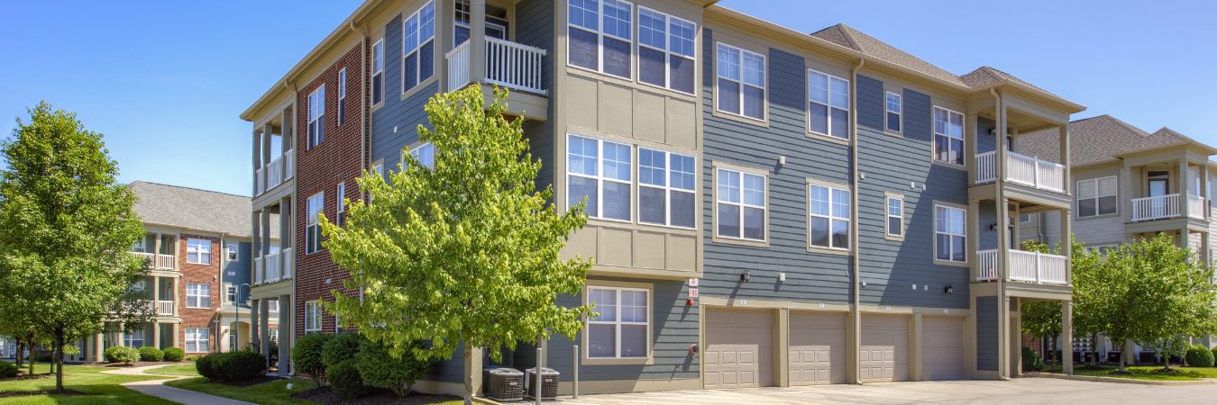 Exterior view of apartment building with garages and balconies